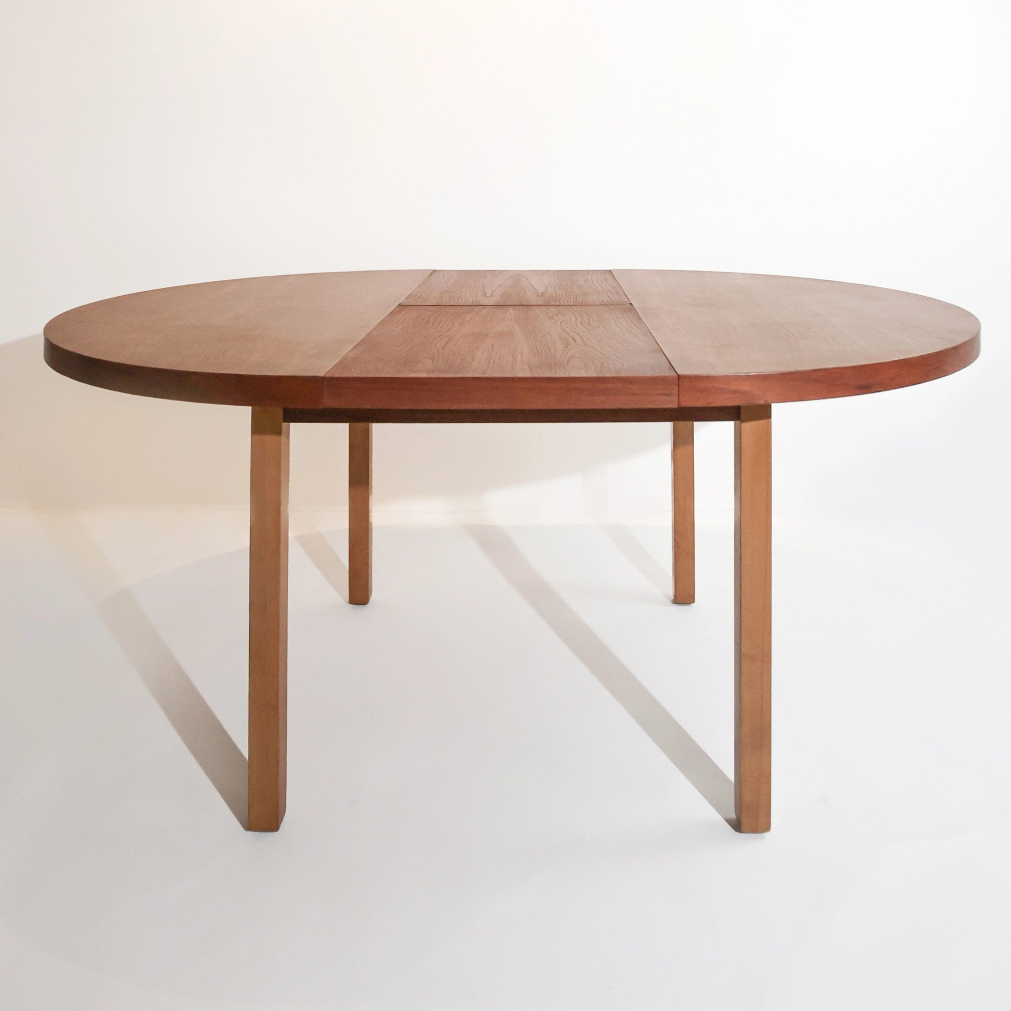 Scandinavian round dining table from the 1960s with a butterfly leaf extension.